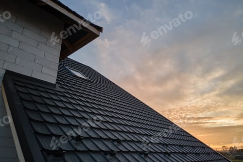 Preview: Closeup of house roof top covered with metallic shingles.Tiled covering of building