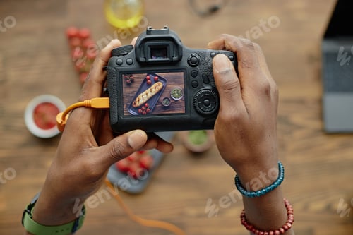 Preview: Young Adult Black Man Photographing Pastry with Digital Camera Indoors
