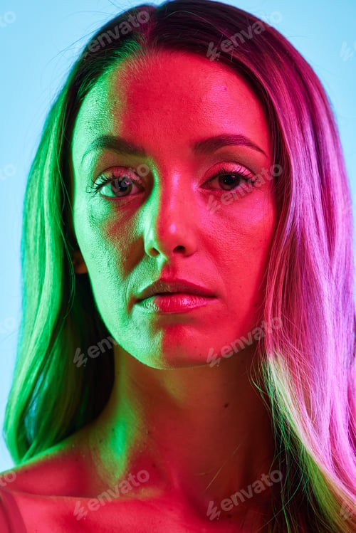 Preview: Skincare, portrait or glowing neon lighting on isolated blue background in self love, healthcare or