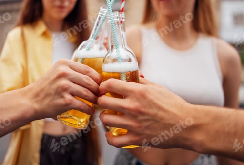Preview: Group of teenagers are having fun and drinking lemonade on street