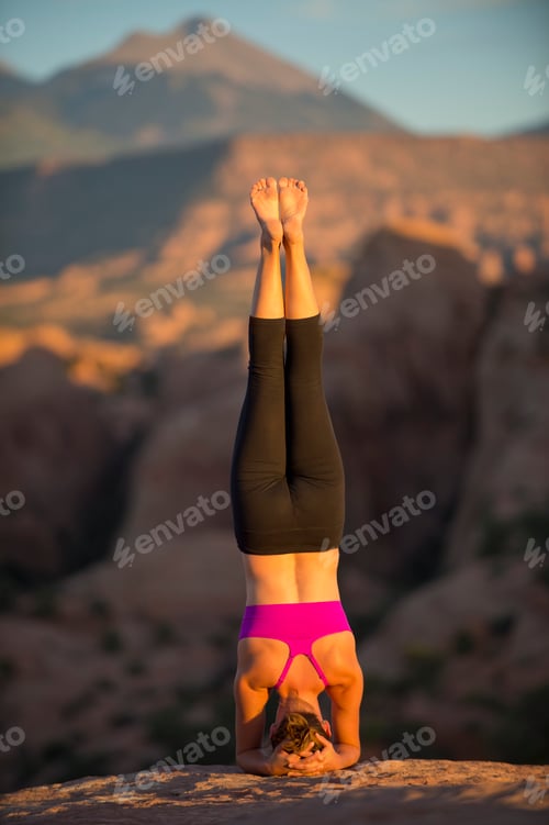 Preview: Young woman doing headstand, Moab, Utah, USA