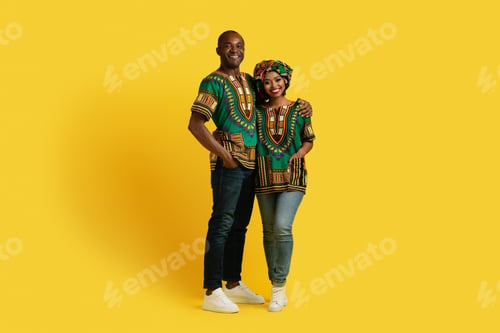 Preview: Happy beautiful black couple in national african costumes embracing