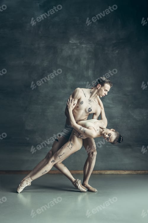Preview: The young modern ballet dancers posing on gray studio background