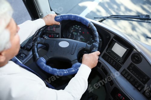 Preview: Professional bus driver at steering wheel. Passenger transportation