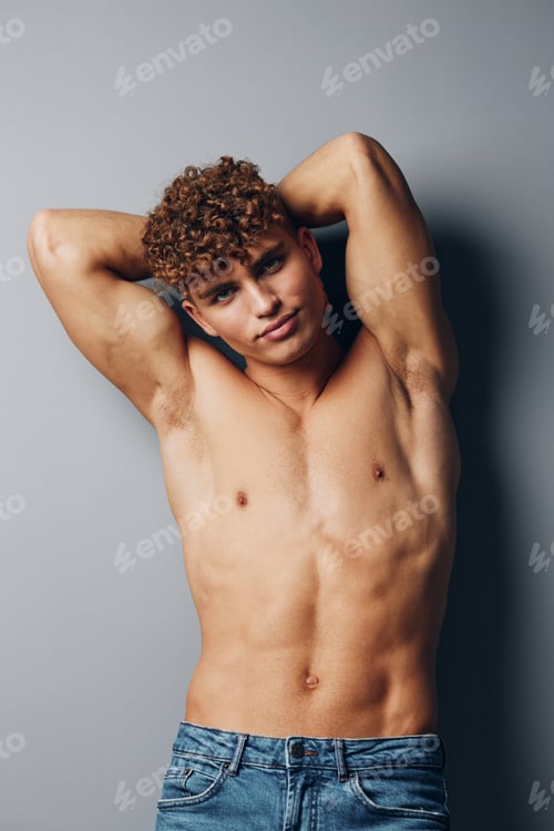 Preview: man young lifestyle attractive curly sexy jeans fashion gray background torso bodybuilder healthy