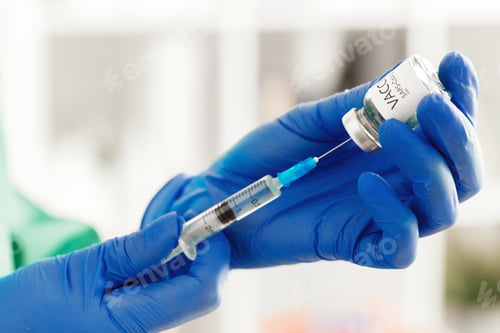Preview: Doctor hands holding covid-19 vaccine preparing for vaccination of a patient