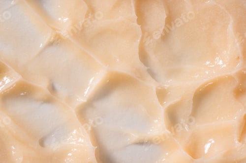 Preview: Hair conditioner cream background. Yellow cosmetic lotion moisturiser sample closeup. Body care balm