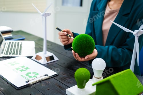 Preview: An Asian businesswoman sits at her desk, discussing clean energy solutions their impact on homes