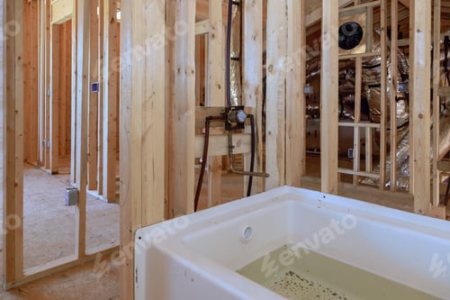 Preview: Under construction house featuring new acrylic bathtub between beams frame in bathroom