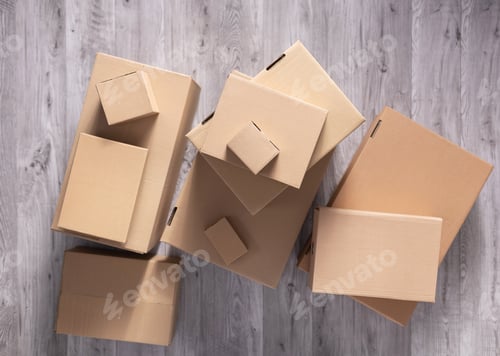 Preview: Stack of cardboard box on floor laminate background. Cardboard boxes for moving to new home
