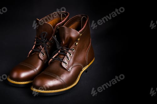 Preview: Fashionable mens leather brown shoes on black background.