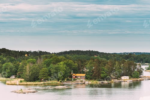 Preview: Sweden. Beautiful Swedish Wooden Log Cabins Houses On Rocky Island Coast In Summer Day. Lake Or