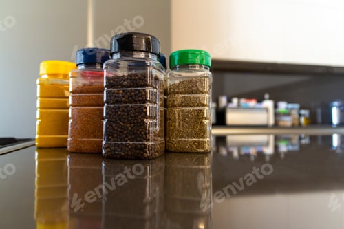 Preview: Set of various spices in bottles on the table
