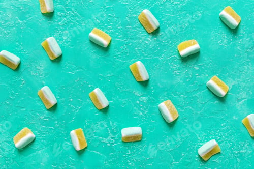 Preview: Fruit jelly candies in the form of melon slices on a bright turquoise background. Food background.