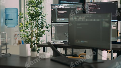 Preview: Empty desk with multiple monitors displaying server code and programming language