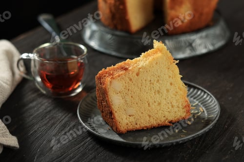 Preview: Sliced Cheese Chiffon Cake on Black Wooden Table