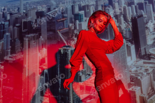 Preview: attractive and stylish woman in red dress on city background