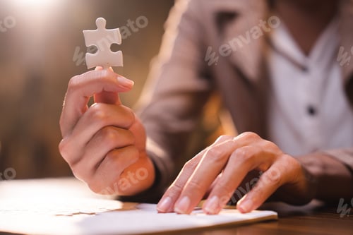 Preview: Business person team work holding jigsaw to connecting successful puzzle piece for matching