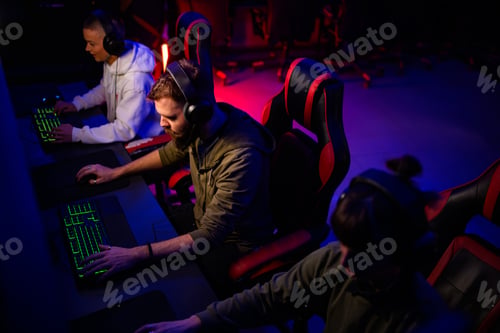 Preview: Young eport gamers team playing a video game in cyber club together
