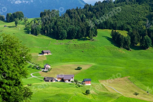 Preview: Panoramic view of countryside, green alpine meadows and mountains