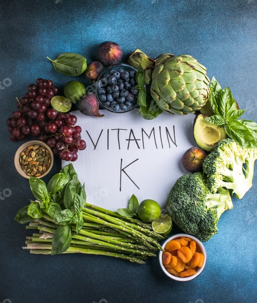 Preview: Vegetables, fruits and text Vitamin K on blue background. Top down view