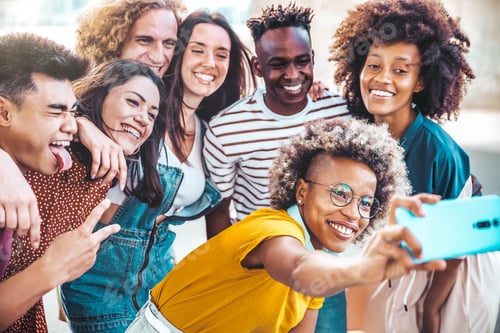 Preview: Multi-ethnic group of friends taking selfie pic with smart mobile phone device outside