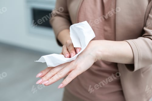 Preview: Woman hand use antibacterial wet wipes or tissue isolated on a white background with clipping path