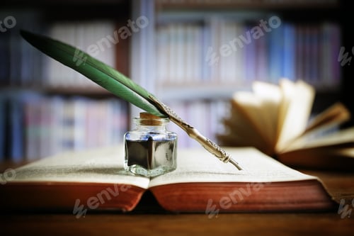 Preview: Quill pen on an old book in a library