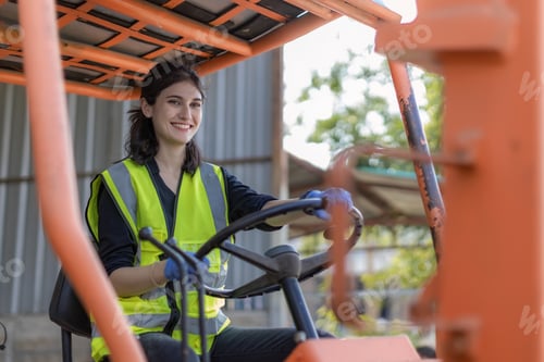 Preview: WoMan worker at forklift driver happy working in industry factory logistic ship.