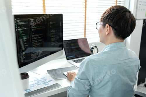 Preview: Male programmer is programming to develop program app and website of corporate while working