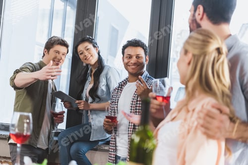 Preview: young people partying, drinking wine at home party