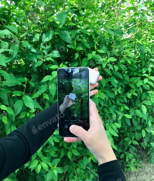 Preview: using white Smartphone. || Outdoors || Natural light || Outside || Hand