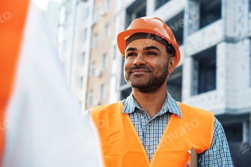 Preview: Portrait of young construction engineer wearing hardhat