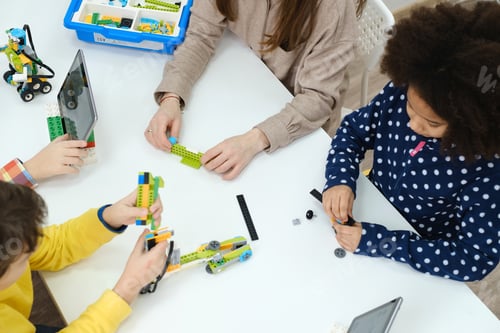 Preview: Multi ethnic kids at technology lesson constructing robot at school