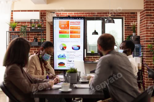 Preview: Diverse businessteam looking at monitor analyzing marketing presentation