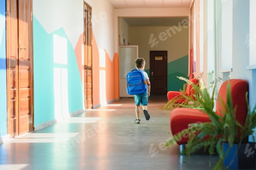 Preview: schoolboy with a backpack in the school hallway