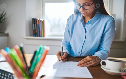 Preview: Young businesswoman busy writing notes