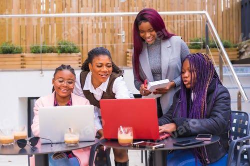 Preview: Young businesswomen of black ethnicity. In a business meeting in a cafeteria