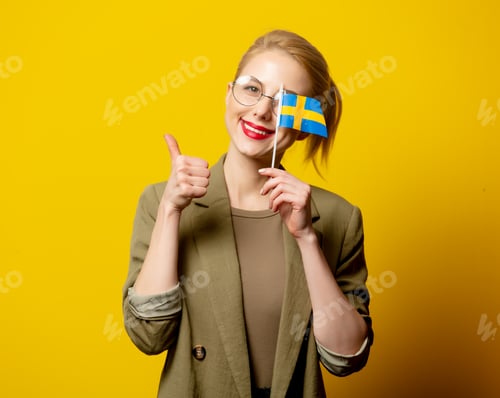 Preview: Style blonde woman in jacket with Swedish flag on yellow background