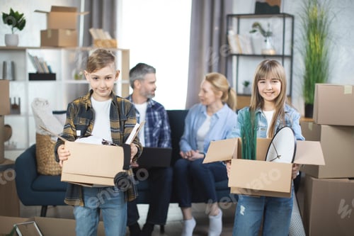 Preview: Smiling kids with moving boxes posing at new flat with parents behind