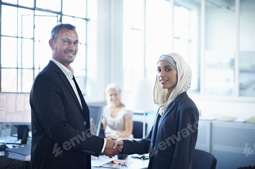 Preview: Portrait of young businesswoman shaking hands with businessman in office