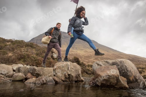 Preview: Couple crossing river, Fairy Pools, near Glenbrittle, Isle of Skye, Hebrides, Scotland