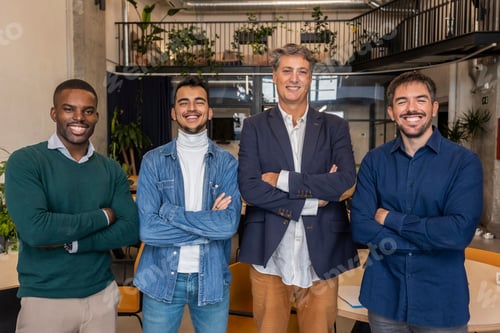 Preview: Startup business team smiling with arms crossed in modern office