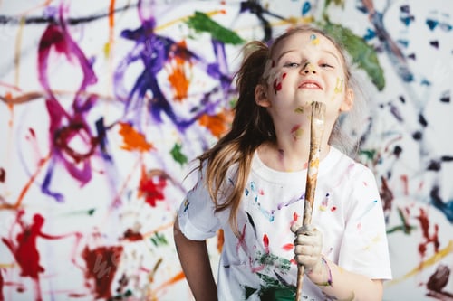 Preview: Young child painter standing with a brush