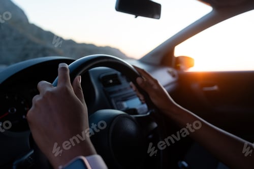Preview: Person driving car on a road at sunset