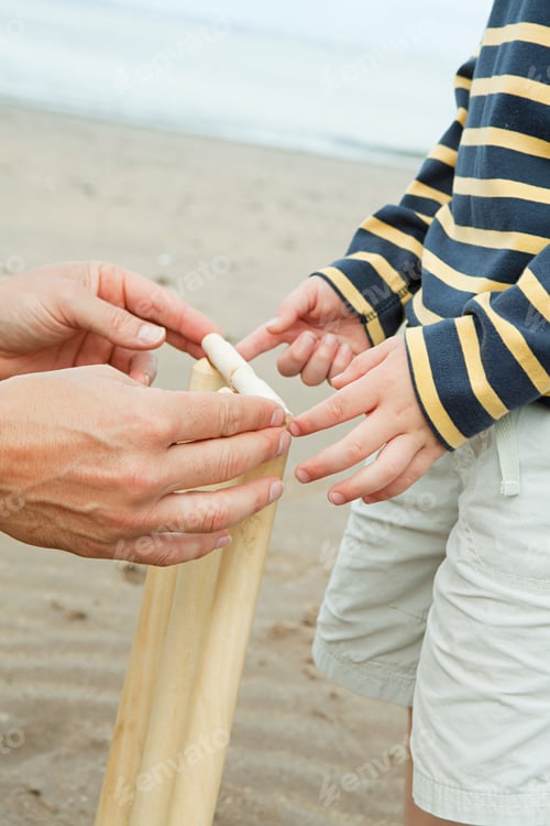 Preview: Adult and child setting up crickets stumps