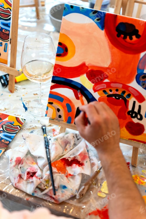 Preview: Friends painting abstract art and drinking wine at workshop