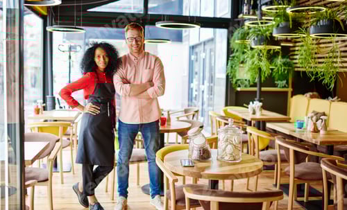 Preview: Glad manager with black colleague in restaurant