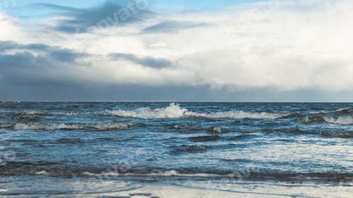 Preview: water and sky with small waves during a cloudy day