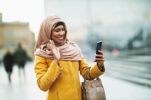 Preview: Black Muslim Woman With Hijab Making A Video Call By Smart Phone On The Street